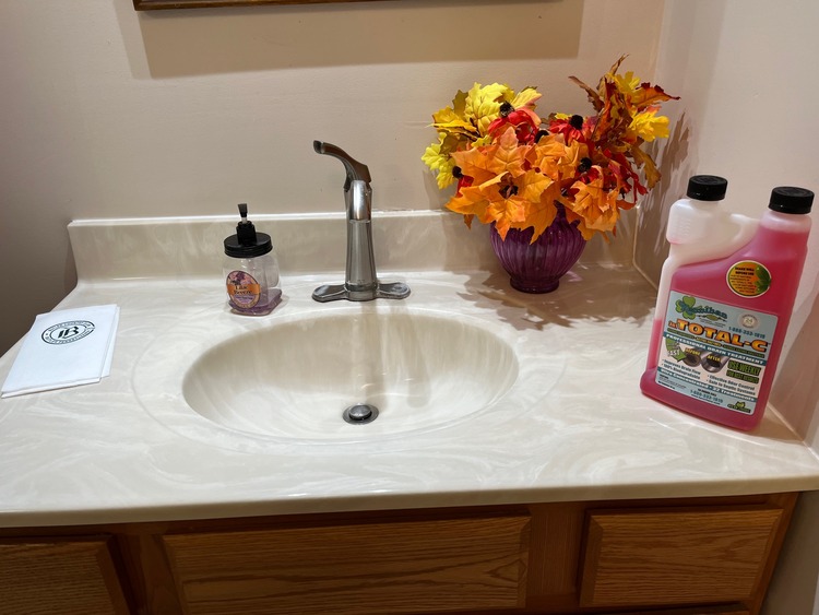 A jug of Total C on a bathroom sink.