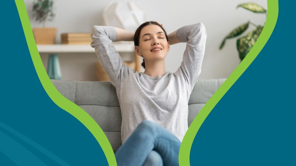 A woman relaxing on her couch, breathing fresh air