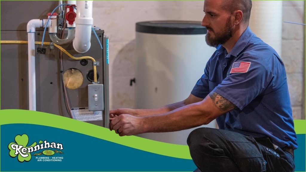 A Kennihan HVAC tech servicing a furnace.