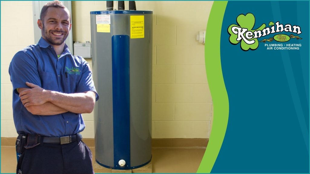 A Kennihan HVAC tech in front of a new water heater.