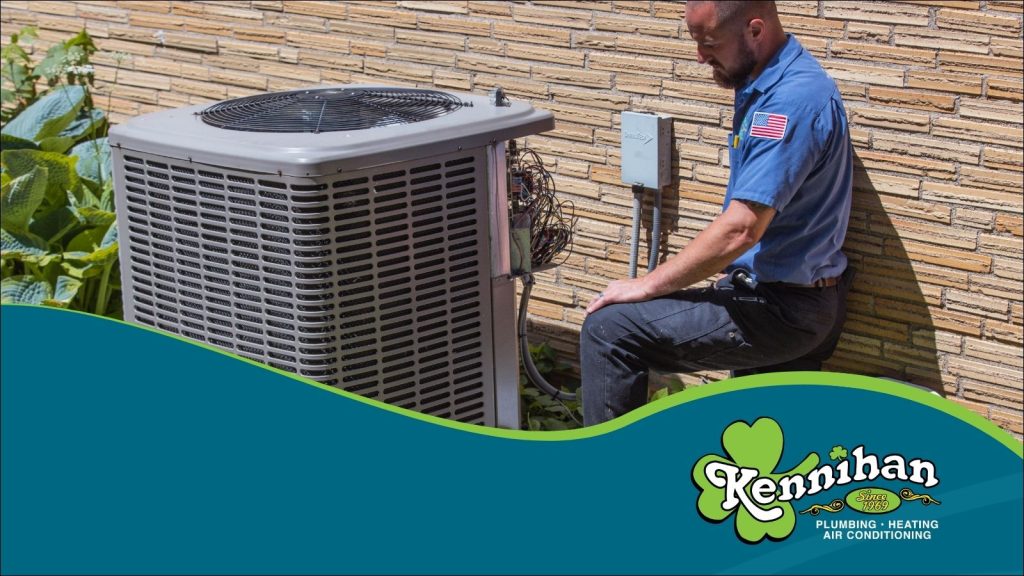 An HVAC tech servicing a AC unit.