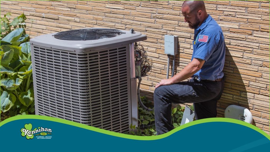 An HVAC tech checking an AC unit.