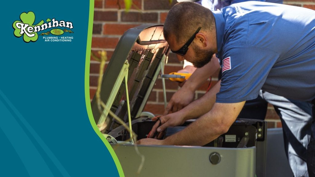 A Kennihan's HVAC tech servicing an AC unit.